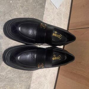 CHANEL Black Leather Loafers with Gold Accents